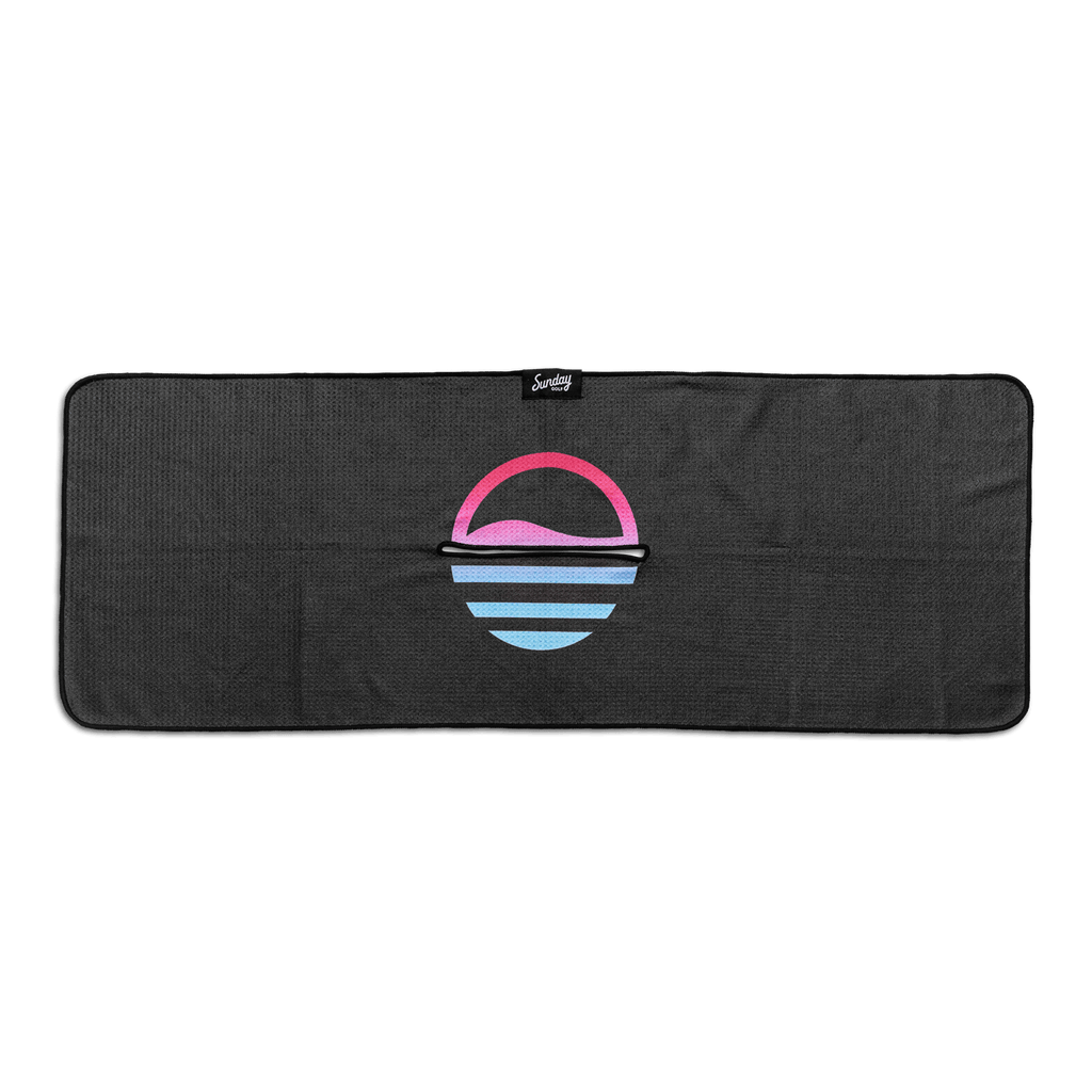 Front view of black golf towel with ombre pink and teal colors