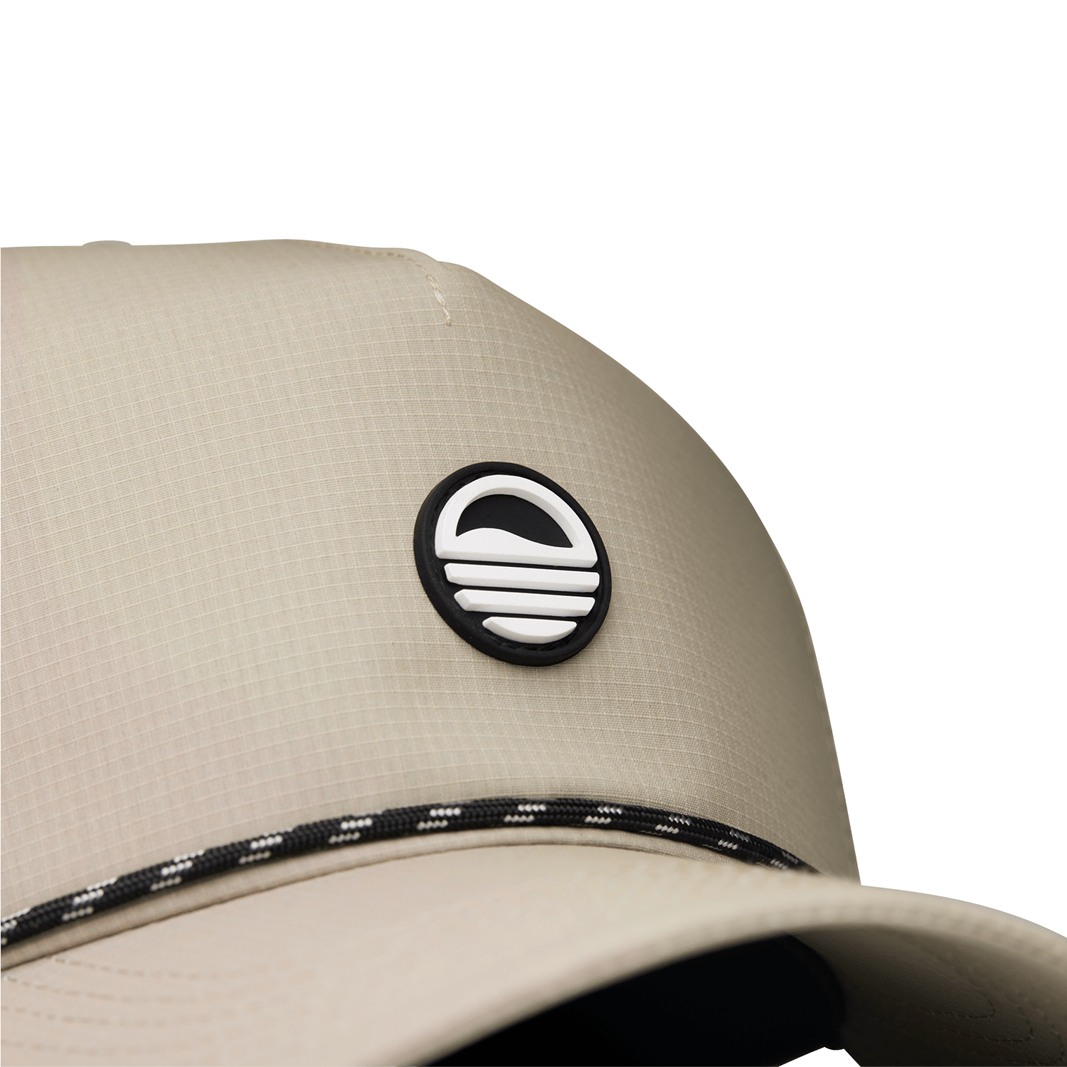 Close up shot of tan Porter Lite golf hat showing Sunday Golf logo