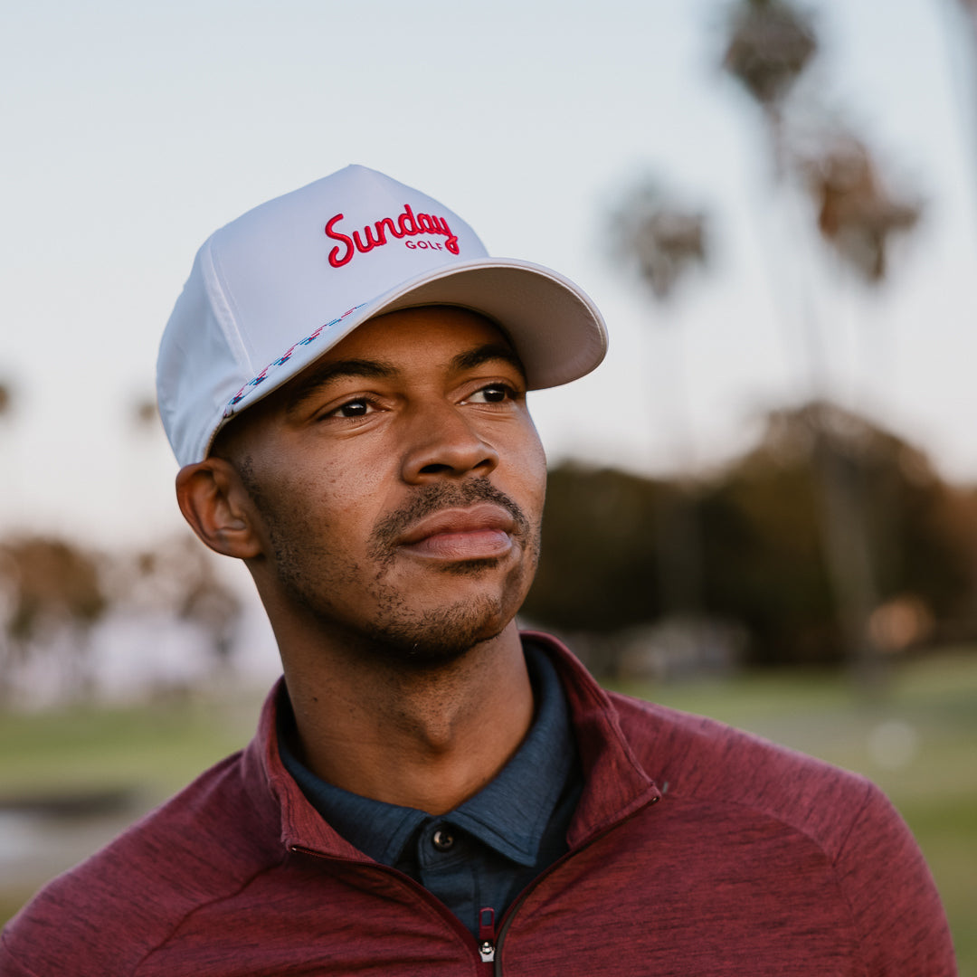 A man wearing usa rope golf hat