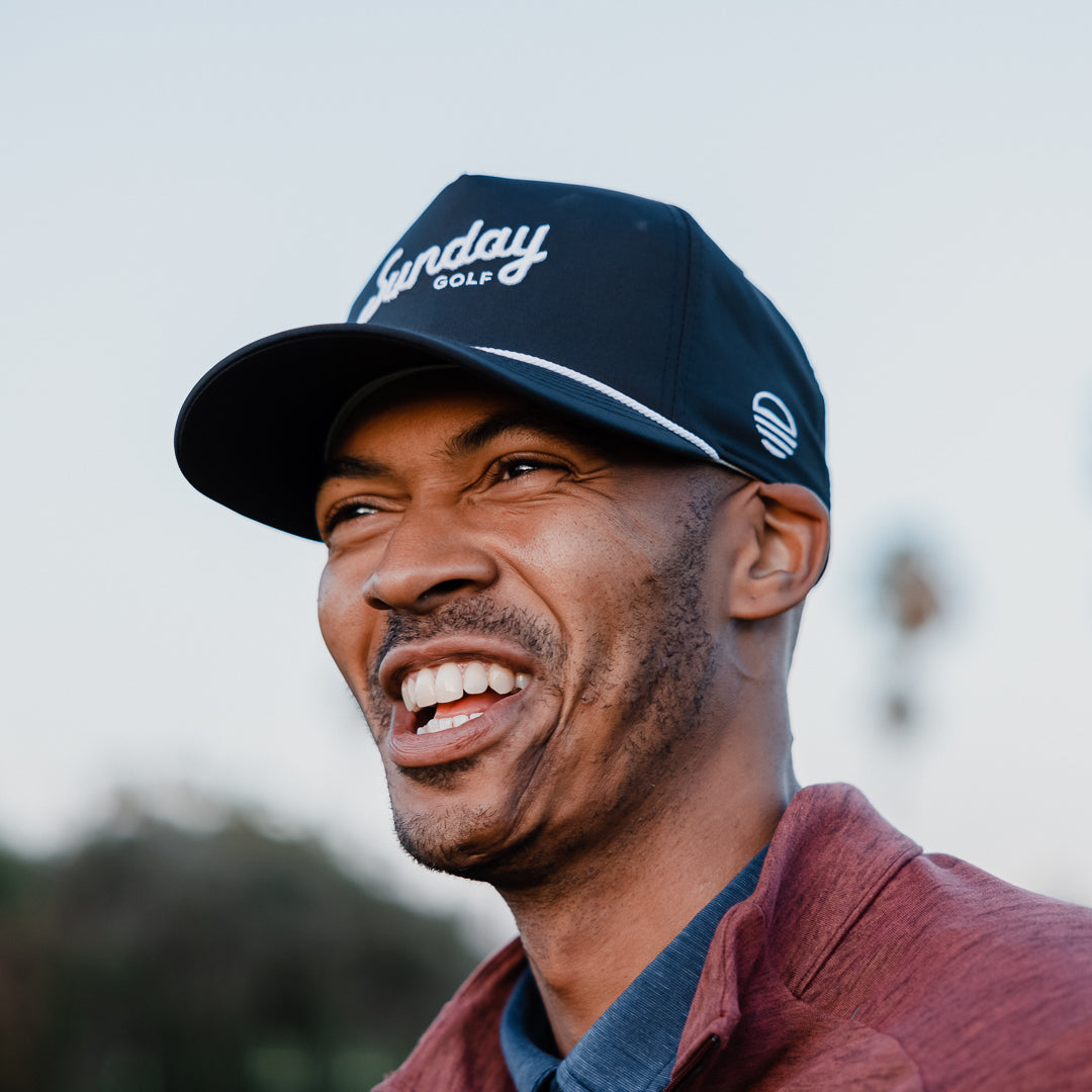 A man wearing navy rope golf hat by Sunday Golf