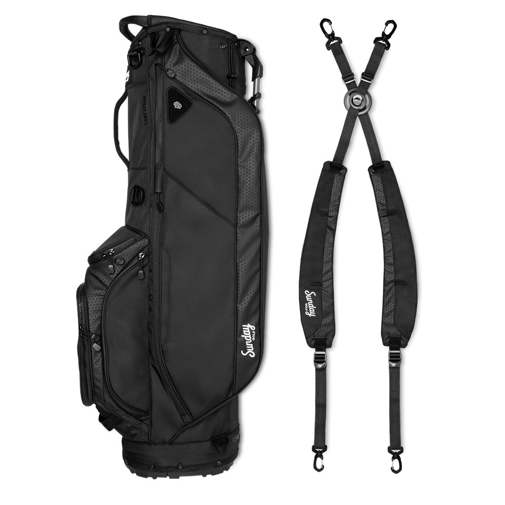 A full shot of Ryder golf bag in matte black laying flat sideways beside its double strap