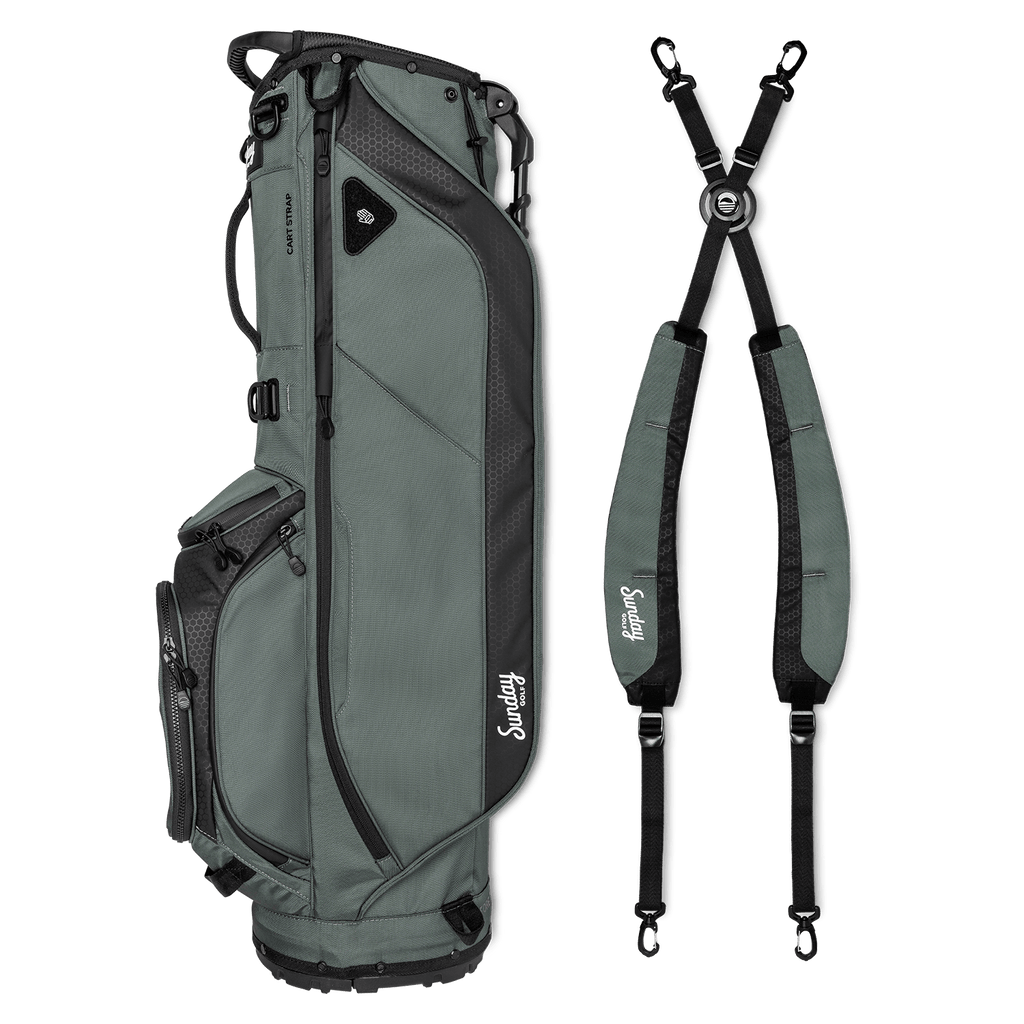 A full shot of Ryder golf bag in midnight green laying flat sideways beside its double strap