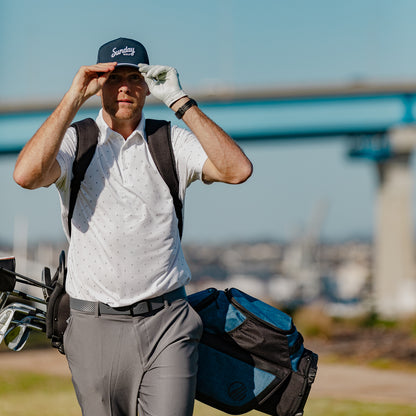A man wearing navy rope golf hat by Sunday Golf with Coronado Bridge in background 