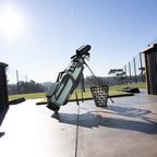A standing seafoam Loma XL golf bag at the driving range 