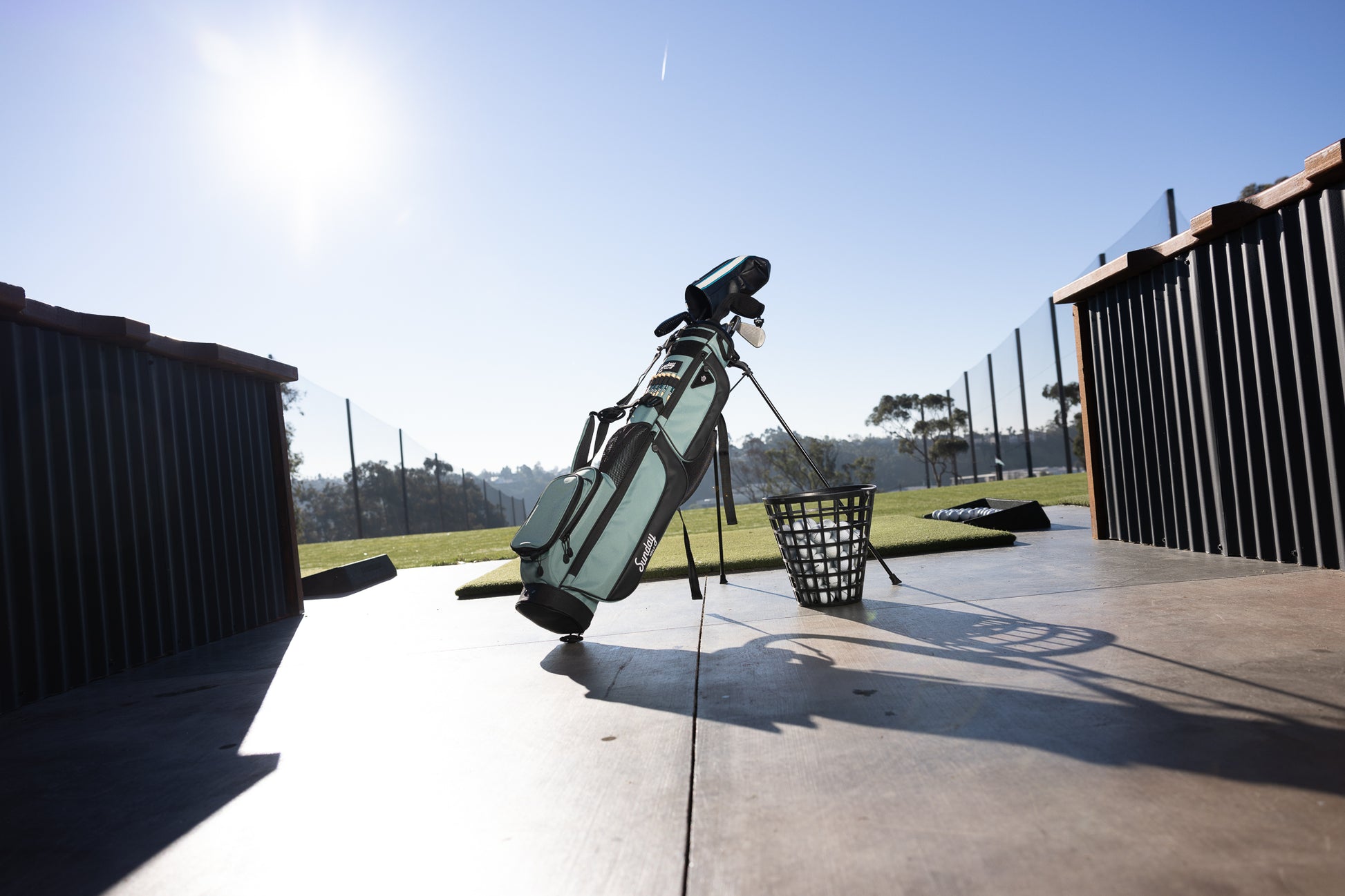 A standing seafoam Loma XL golf bag at the driving range 