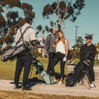 A man standing with heather gray El Camino golf bag, a woman standing with seafoam El Camino golf bag, and a man sitting with matte black El Camino golf bag
