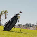 A full front shot of standing Ryder golf bag in midnight green on the course