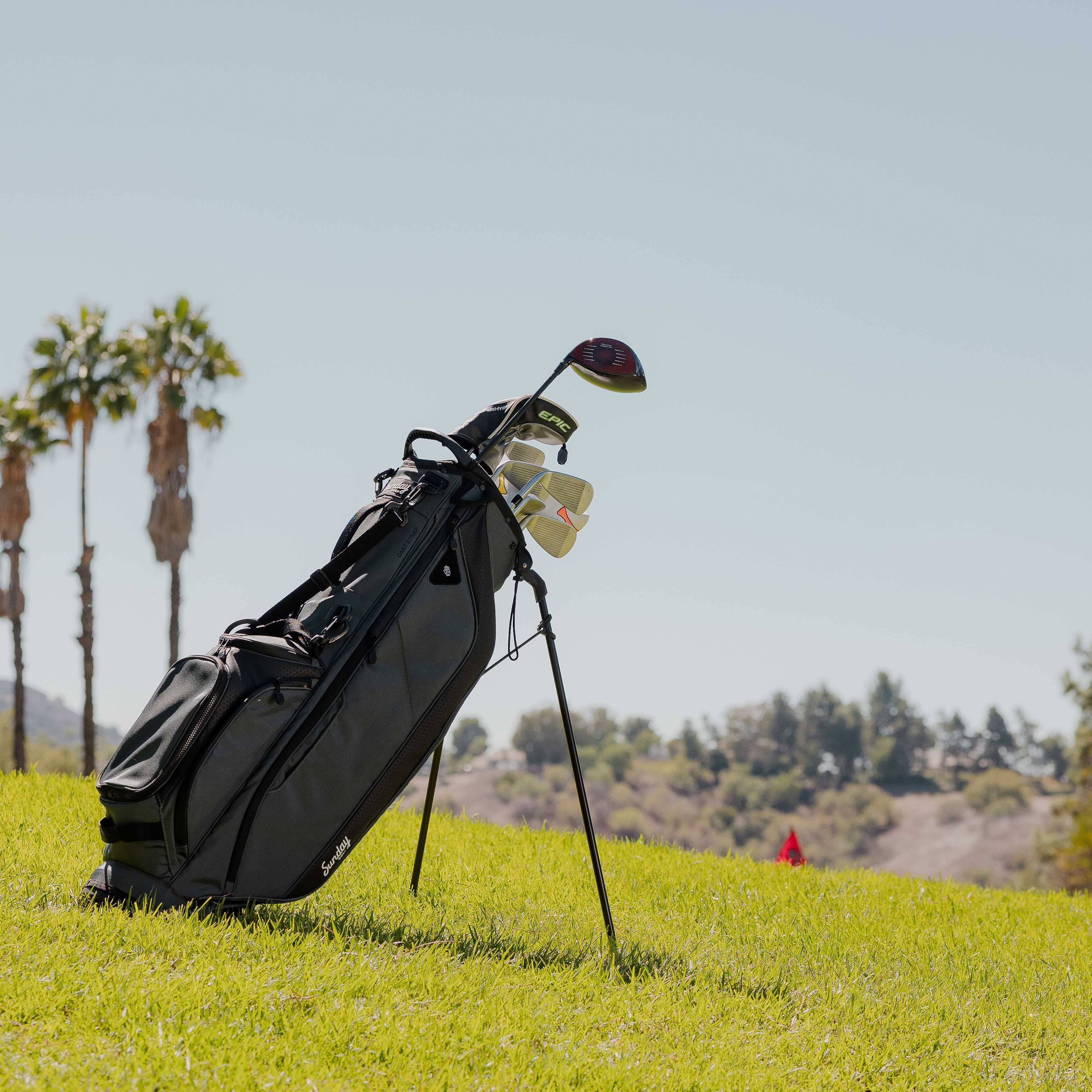 A full front shot of standing Ryder golf bag in midnight green on the course