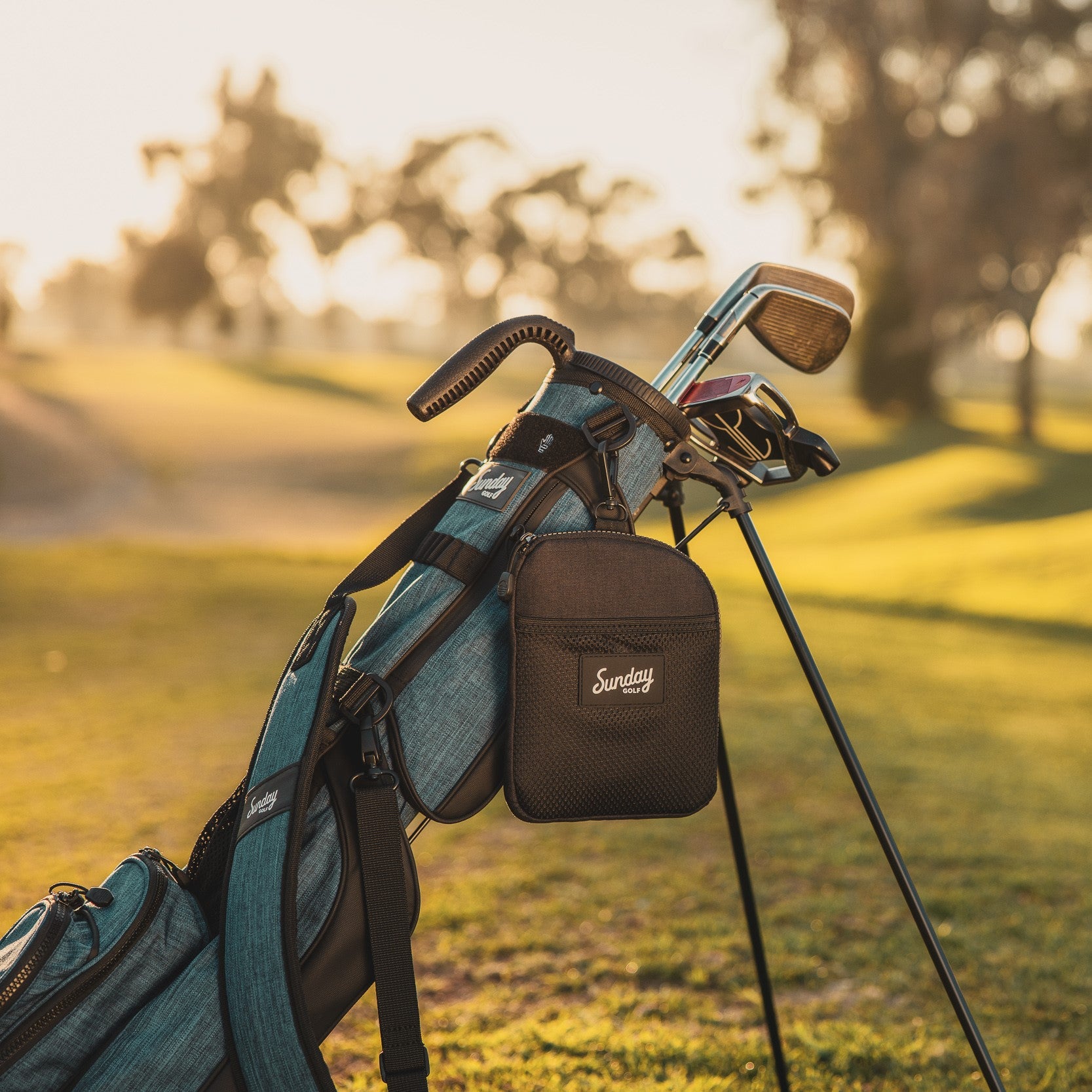 Matte black nickel bag valuables pouch clipped on Loma golf bag in cobalt blue